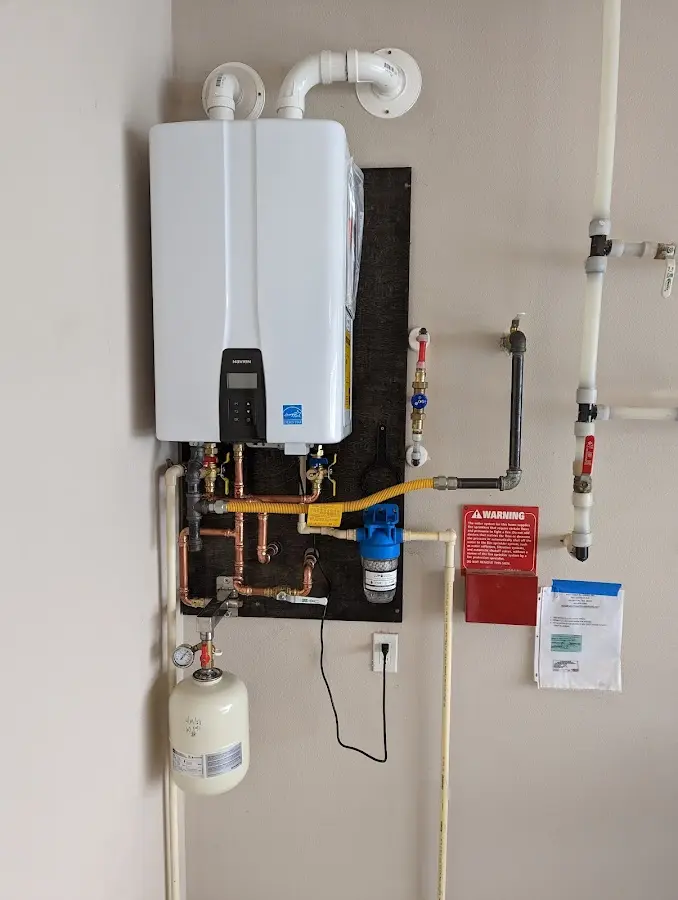 Professional plumber installing copper piping in a Farmersville home